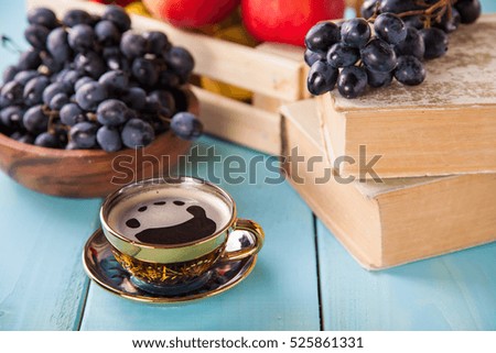 coffee in a cup, grapes and apples on a table, selective focus, copy space