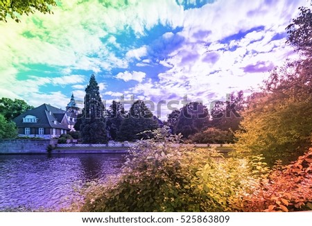 Architectural buildings along Alster canal in Hamburg Germany. Luxury old mansions in Winterhude neighbourhood on a summer day for real estate agent business, realtor blog. Image with rainbow filter
