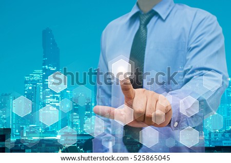 businessman point on virtual screen with night modern city building background