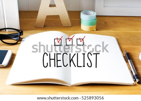 Checklist concept with notebook on wooden desk 
