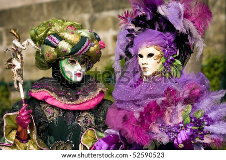 Performers in costume gathered on a quay of the river Seine for a Venetian carnival parade in Paris, France