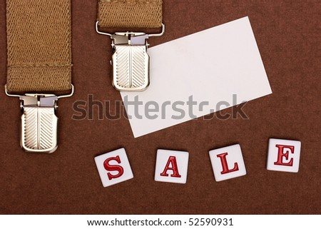An accessory from man's clothes, a place for business of a card and an inscription made of plastic letters Sale.