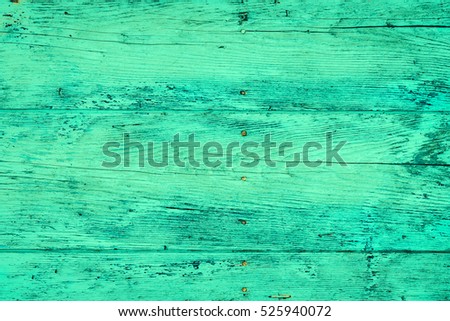 Wood plank fence in green and turquoise colors close up. Detailed background texture. Wooden wall abstract background.