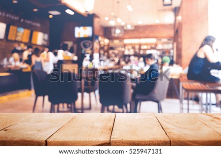Empty of wood table top on blurred of people in coffee shop (cafe restaurant ) with light gold color background.For create product display or design key visual layout