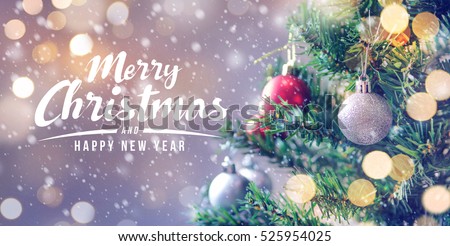 Merry Christmas and happy new year concept, Closeup of white bauble hanging from a decorated tree with bokeh, Xmas holiday background. Royalty-Free Stock Photo #525954025