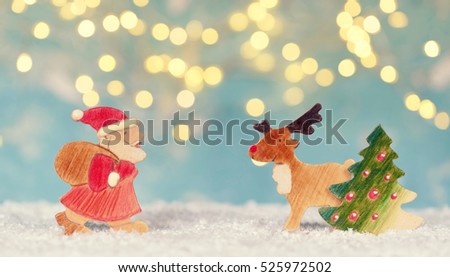 Cute wooden Christmas characters - Santa Claus, Christmas tree and reindeer standing in snow                                 