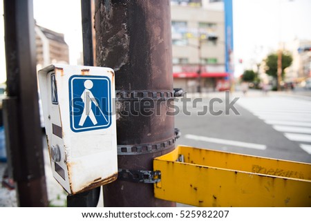 Tilt photography focus on feet of a walking man crossing street in Japan