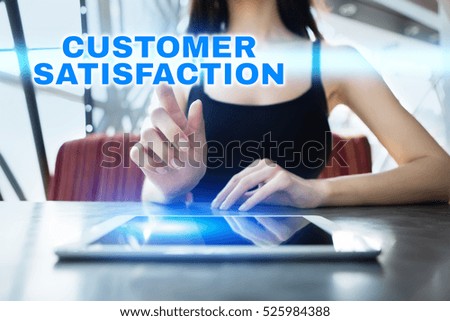 Woman is using tablet pc, pressing on virtual screen and selecting customer satisfaction.