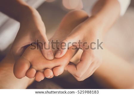 Young woman having feet massage in beauty salon, close up view Royalty-Free Stock Photo #525988183