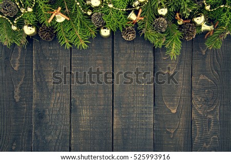 Frame from decorated Christmas tree on rustic wooden background with copy space for text. Happy New Year concept. Holiday background. Christmas mock-up or greeting card. Top view