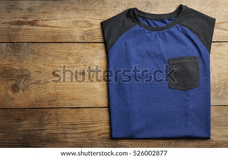 Blank dark t-shirt on wooden background