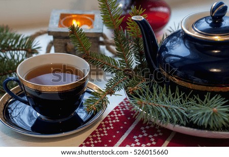 Set of decorative porcelain cup, plates, teapot with blue and gold pattern in the xmas style with tea. Food photo, Christmas concept