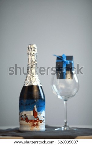 Champagne bottle with christmas picture on fir tree branch background