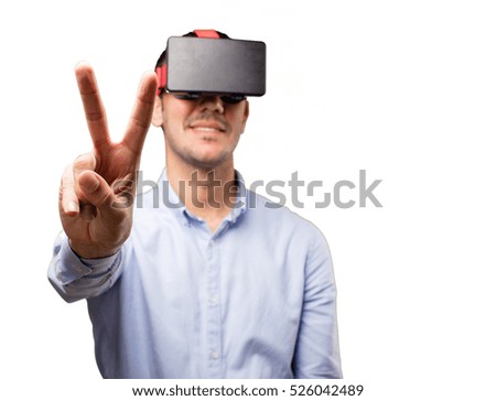 Young man using a virtual glasses against white background