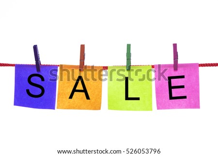 Colorful paper cards with words SALE hang on rope isolated on white.