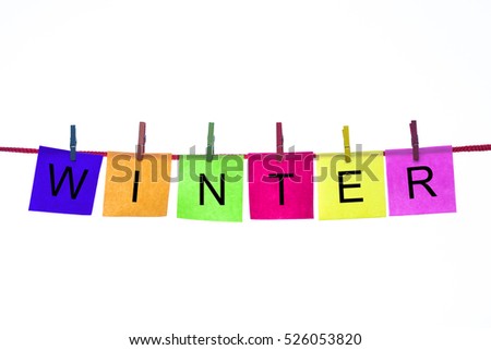 Colorful paper cards with words WINTER hang on rope isolated on white.