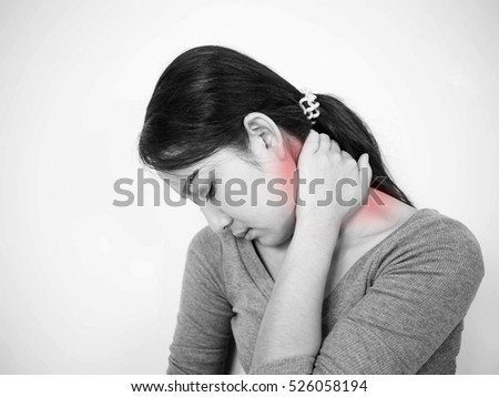 Close up of woman having neck pain black and white tone.Concept photo with Color Enhanced blue skin with read spot indicating location of the pain; Healthcare Concept ;Medical Concept 