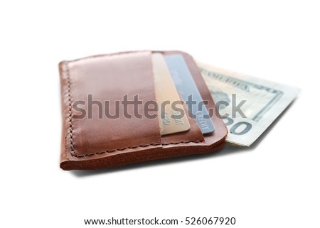 Brown leather wallet with credit cards and money isolated on white