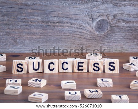 Success from wooden letters on wooden background
