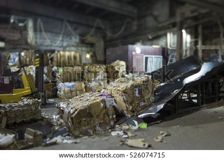Tilt-Shift photo.  Conveyer for Paper recycling. Paper production . Processing of secondary resources. Large enterprise. Royalty-Free Stock Photo #526074715
