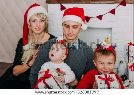 Portrait of friendly family looking at camera on Christmas evening