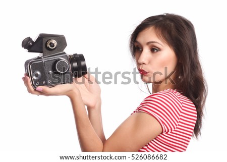 Portrait of a young woman taking a picture with a camera. 