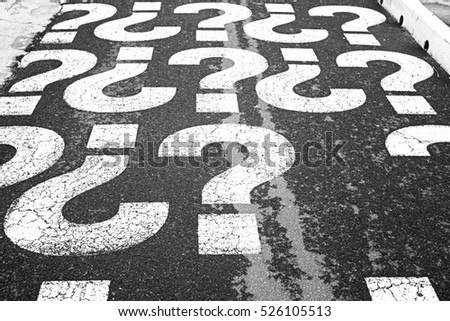 Question marks on urban street, symbol Royalty-Free Stock Photo #526105513