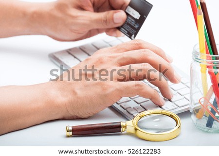 Person do transaction and entering number of credit card with white workspace