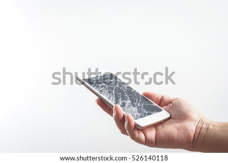 Man hand holding mobile phone with broken screen