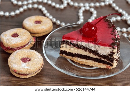 Delicious chocolate-cherry cake on plate on table