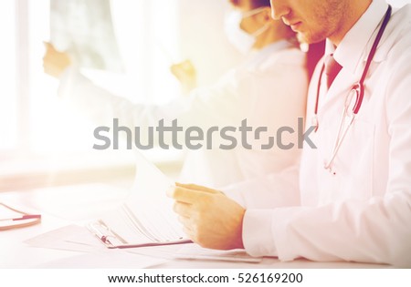 healthcare, medical and radiology concept - two doctors looking at x-ray