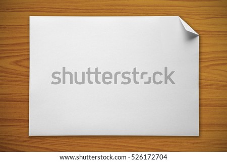 Blank white paper on a wooden background