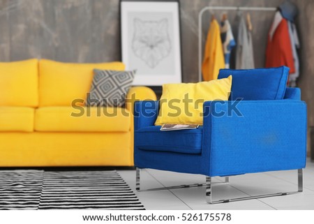 Dark blue armchair on gray wall background
