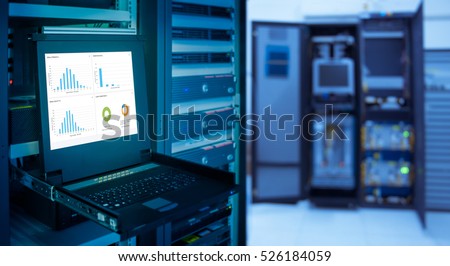 monitor show graph information of network traffic and status of device in server room data center and blur background. blue tone Royalty-Free Stock Photo #526184059