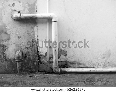 black and white street wall with pipe