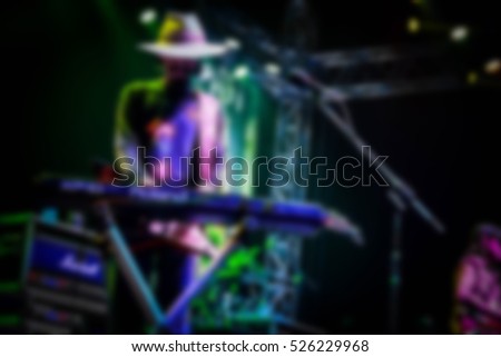 Blurred background : Bokeh lighting in concert with audience ,Music showbiz concept,
music performance concert with bokeh spotlight. entertainment concert lighting on stage, blurred disco party.