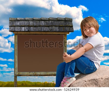 A young girl sitting on a boulder in front of a wooden sign, outside on a partly cloudy day.
