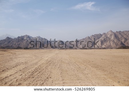 Desert on a background of mountains Royalty-Free Stock Photo #526269805