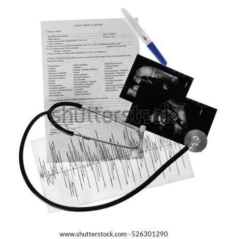 Ultrasound scan of baby and stethoscope on white background