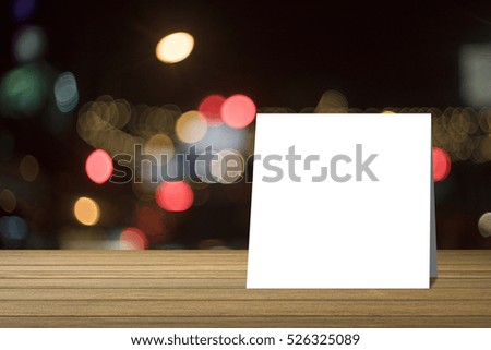 white card put on Wooden desk or wooden floor on night light bokeh background.use for present or mock up your product.clipping path include