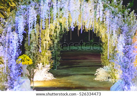 Beautiful LED lights and flowers archway for photo taking in wedding ceremony.