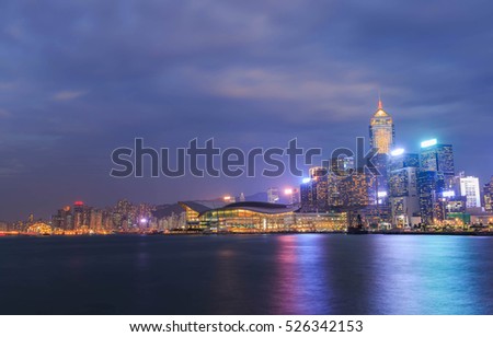 Hong Kong city skyline at night  Victoria Harbor with clear sky and urban skyscrapers.