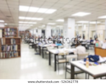 Blurred image of people reading, searching for books and preparing for the final examination in library at university
