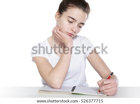 bored teenage girl is doing her homework