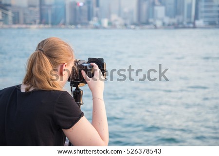 Woman photographer take a image Cityscape at Hong kong city.