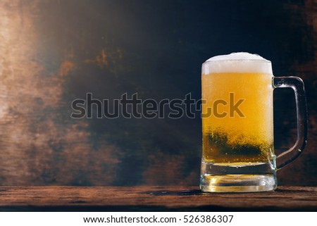 Glass beer on wood background with copy space Royalty-Free Stock Photo #526386307