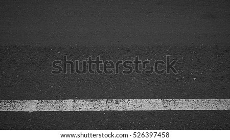 Surface rough of asphalt, Grey with white line on the road and small rock, Texture Background.