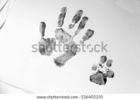 Handprint and dog painted on paper, animal adoption Royalty-Free Stock Photo #526403335