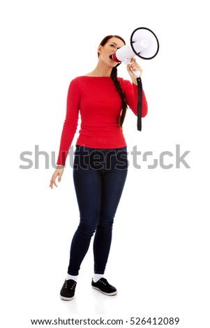 Young angry woman screaming through a megaphone