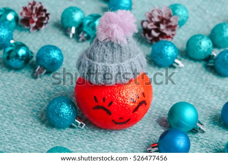 tangerine in a Christmas woolen hat .Xmas New Year concept